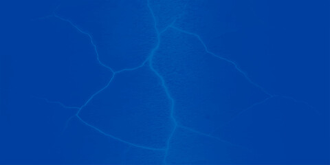 Blue light energy creates a clear, seamless ripple pattern on the water's surface, reflecting the electric blue sky background