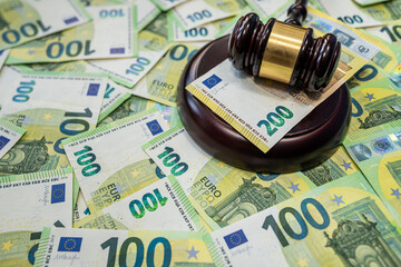 100 Euro money and judge hammer representing law and corruption