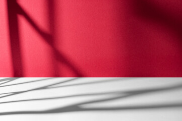 Window shadows cast on red and white surfaces.