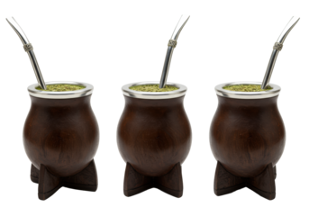 three richly stained dark wooden yerba mate gourds with intricate silver bombillas, professionally photographed on a transparent background. concept of authentic south american tradition