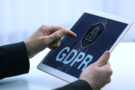 General Data Protection Regulation. Man using tablet computer with shield, padlock and GDPR abbreviation, closeup. Privacy security - Powered by Adobe