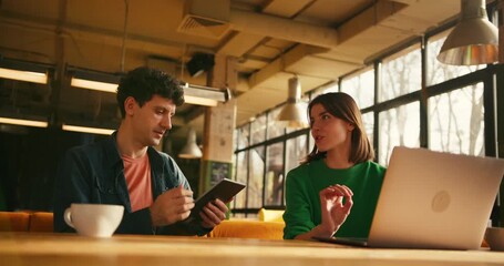 Young colleagues discussing business project in cafe or modern coworking - Powered by Adobe