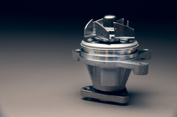 Engine cooling pump, engine coolant pump for a passenger car on a black gradient background. Selective focus