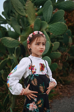 Little girl in colorful costume with flower crown