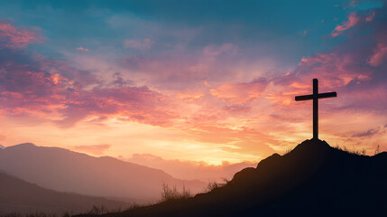 Silhouette of a cross on a hill during a colorful sunset with vibrant clouds and mountain landscape in the background symbolizing hope and faith