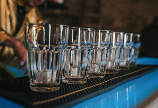 Bartender preparing cocktails at a bar counter
