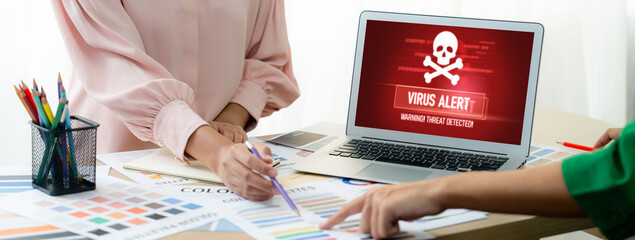 Virus warning alert on computer screen detected brisk cyber threat , hacker, computer virus and...