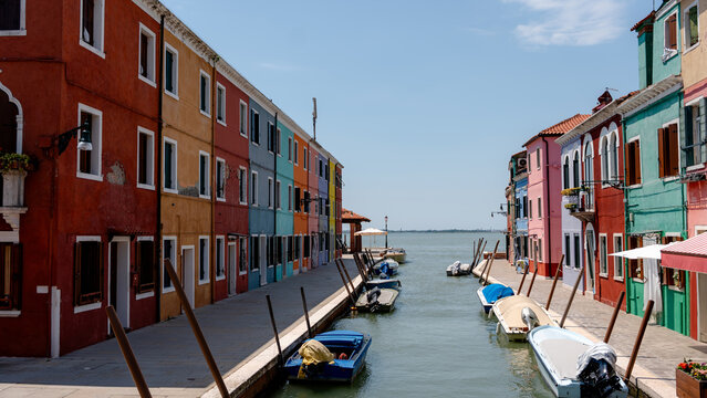 Colorful houses and boats in a Burano canal