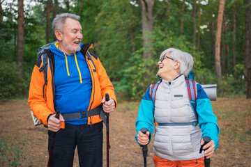 Hiking tourism adventure. Senior couple man woman enjoying outdoor recreation hiking in forest. Happy old people backpackers hikers enjoy walking hike trekking tourism active vacation beauty of nature