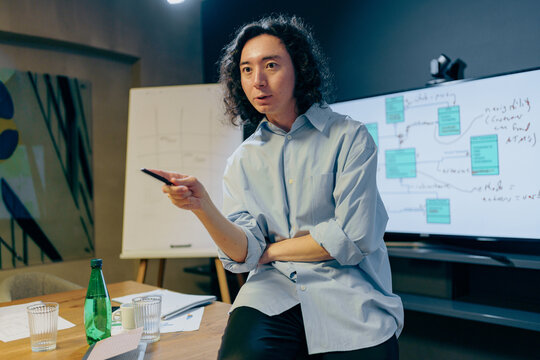 professional presenting with visuals, trustworthy asian expert sharing insights with clients confidently