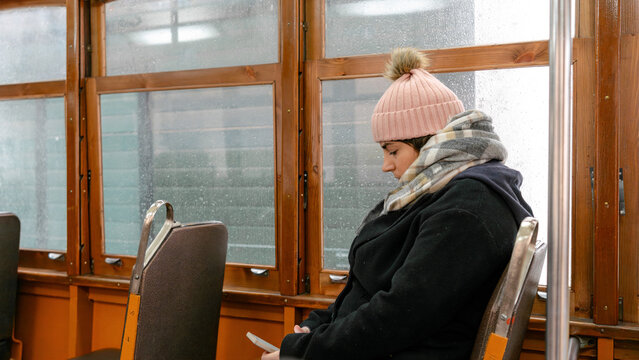 Woman on a rainy day in classic Lisbon tram