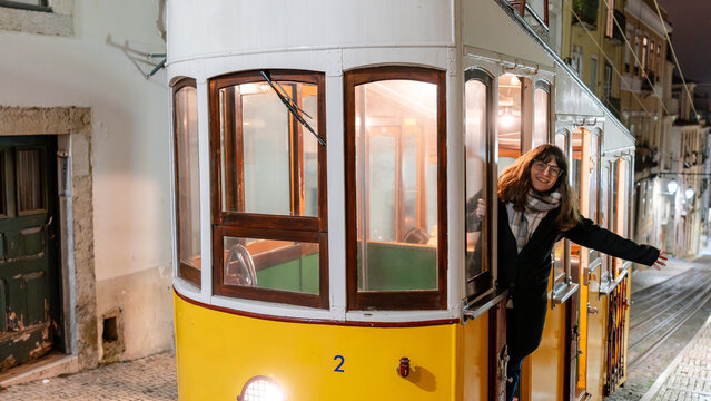 Woman on Bica funicular at night in Lisbon