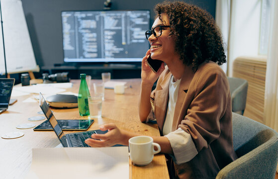 woman checking code while drinking coffee, individual analyzing programming on computer screen