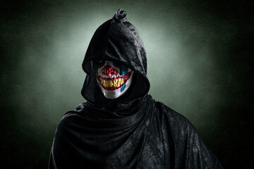 Portrait of a scary clown over dark misty background with clipping path