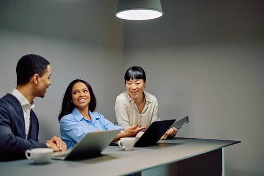 Diverse business professionals discussing projects and ideas during a productive meeting in a modern office, fostering teamwork and collaboration