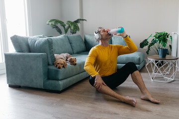 Man training at home with dogs relaxing nearby