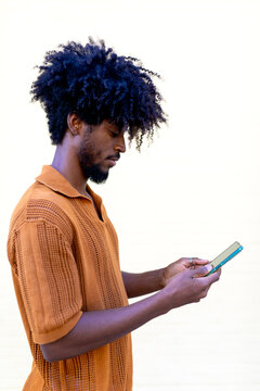 Man using smartphone with thoughtful expression