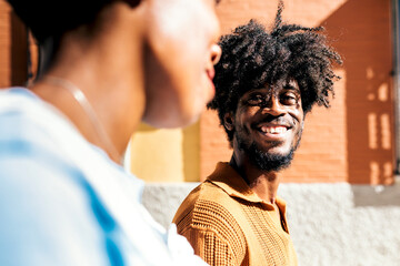 Smiling man interacting with woman outdoors