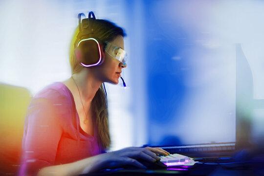 Woman with cyber headphones against bokeh light background