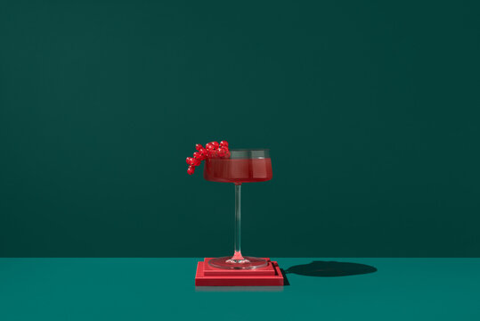 Red currant juice in a glass with a dark background