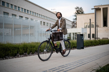 Businessman riding bicycle in urban environment