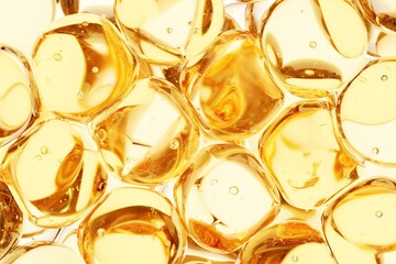 Close-up of golden translucent gel capsules filled with microbubbles, perfect for supplement marketing, medical visuals, and clean high-end product advertising backgrounds