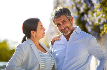 Fototapeta premium Middle-aged couple sharing a tender and playful moment outdoors
