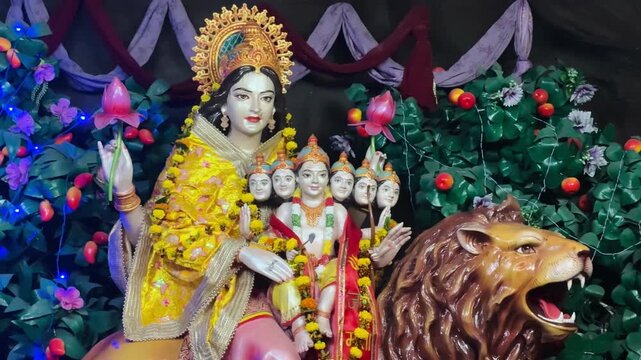 Multi-faced Goddess Idol Durga adorned with colorful attire and ornaments, representing divine wisdom and cosmic energy.
