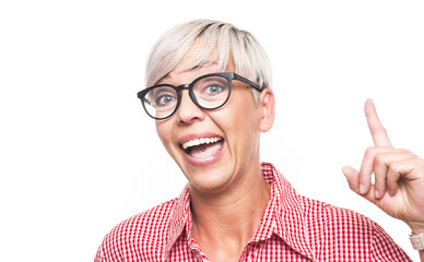 Idea gesturing. Surprised adult woman pointing up with his finger, isolated on white background. Amazed middle aged woman with open mouth.