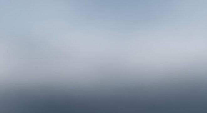 Misty horizon over a calm blue body of water