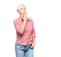 Adult woman yawns. Sleepy middle aged woman yawning, isolated on white background.