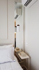 Elegant Bedroom with Cozy Bed, Light Decor, and Warm Sunlight. Vertical photo 