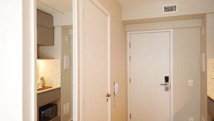Small Kitchen in light colors Reflected in Decorative Boiserie Mirror. Studio apartment