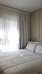 Elegant Bedroom with Cozy Bed, Light Decor, and Warm Sunlight. Vertical photo
