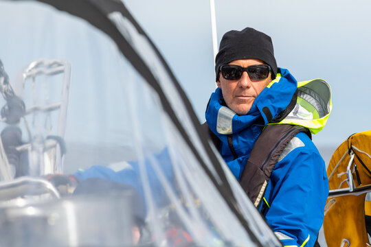 Man sailing in Norway amidst stunning fjords