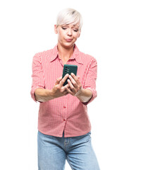 Confused adult woman holding the mobile phone, isolated on white background. Female person with annoying expression holding smartphone. Nuisance concept.