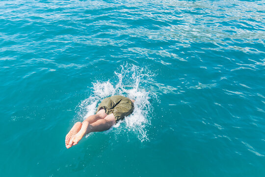 Man diving into the clear Mediterranean sea water