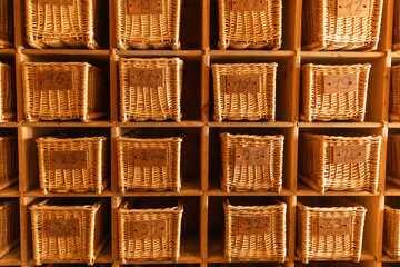 Wicker baskets in wooden shelving display