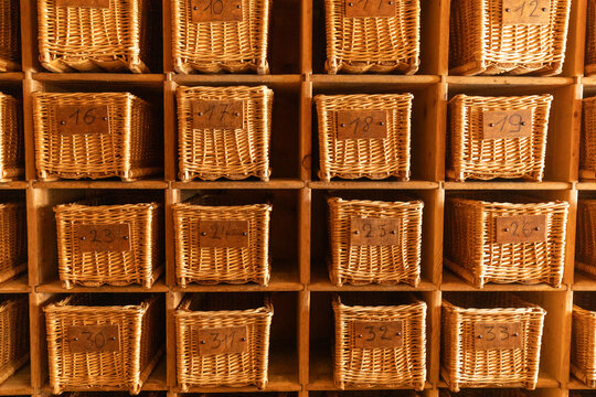 Wicker baskets in wooden shelving display