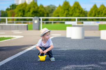 Toddler playing with yellow kettlebell