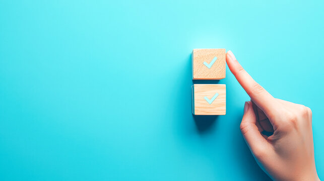Hand selecting a checked box on wooden blocks against a blue background