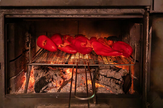 Roasting red peppers in a wood-fired oven