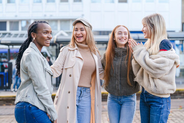 Friends enjoying a sunny day outdoors while laughing and sharing stories in the city