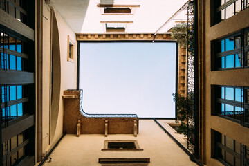 Looking up at the sky through a courtyard in Verona, Italy, on a sunny day.