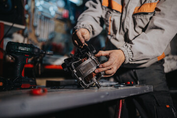 A skilled technician works on a complex mechanical part in a busy workshop, using a drill and precision tools. Focused hands, safety gear visible, conveying hands-on maintenance and repair work.