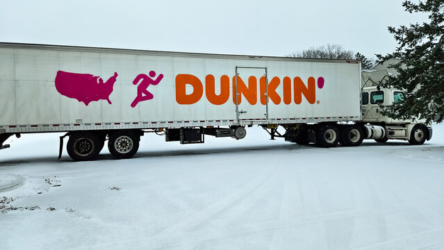 A semi-trailer truck with the Dunkin' Donuts logo and color scheme on a winter day in Minnesota, USA (November 29, 2025). For Editorial Use Only.