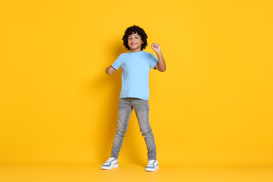 Portrait of little boy on yellow background