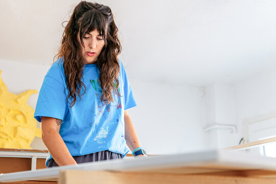 Visual artist preparing canvas in bright studio