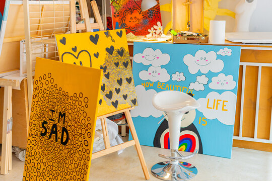 Creative artistic workshop filled with vibrant paintings