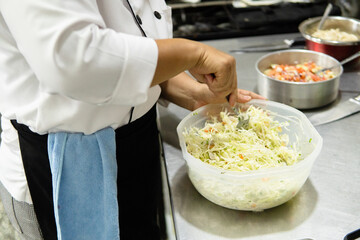 Chef preparing fresh salad during cooking class